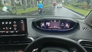 driving a car while enjoying the rain