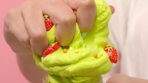 Woman squeezing green plasticine into ice cream shape