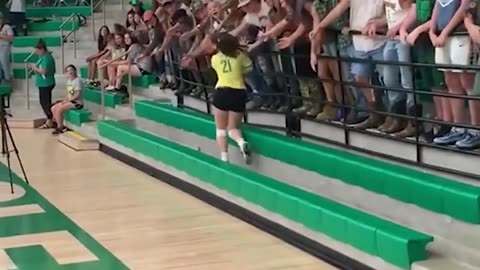 cheerleader goes to give fans hi fives and the railing gives way.