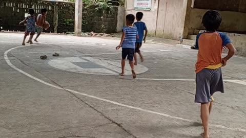 Kids playing basketball without shoes!