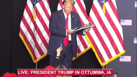 President Trump autographs his West Point picture from someone in the audience