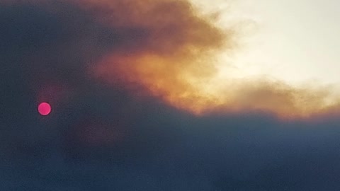 The sun turned red behind a cloud of smoke.