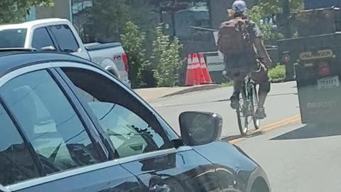 Crazy biker hitches a ride from back of truck