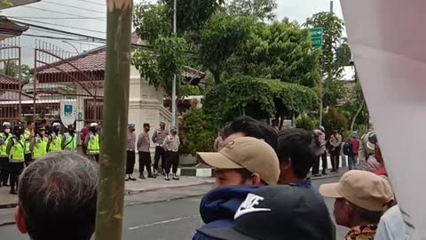 Indonesian police guard the demonstrators