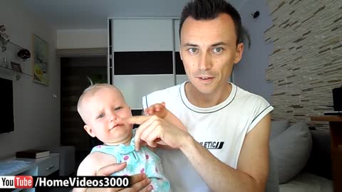 Adorable baby girl blowing kisses and imitating Daddy