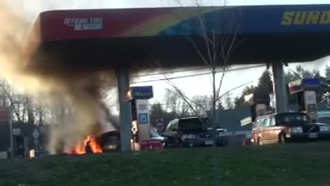 Car burning up at gas station small explosions