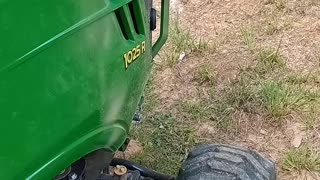 John Deere 1025R mowing a bank