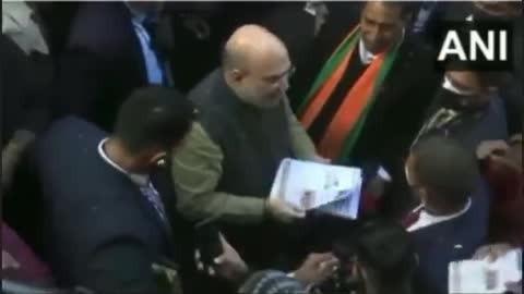 Amit Shah distributing the form by spitting