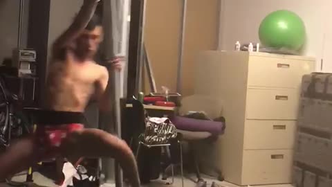 Guy in red and white underwear spins on pole