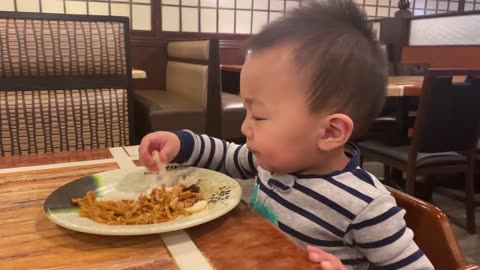 Toddler enjoys rice