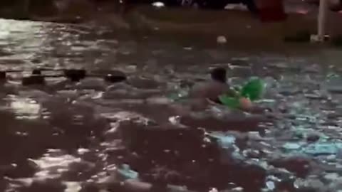 man rafting in Las Vegas flooded streets