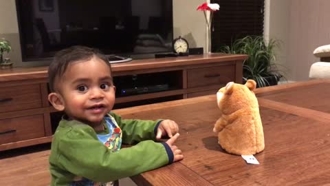 Baby has conversation with repeating hamster toy