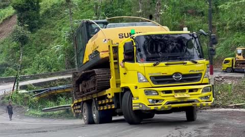 Two Selfloader Trucks Load Excavator Across Extreme Roads