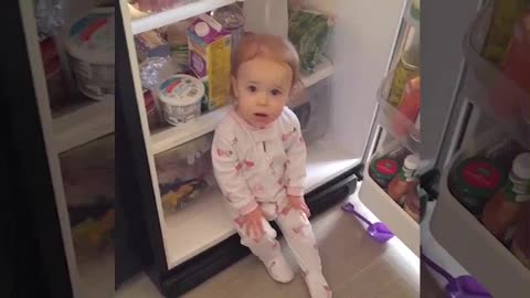 This baby sees the refrigerator as home of comfort