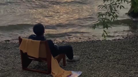 Boy blowing wind by the sea