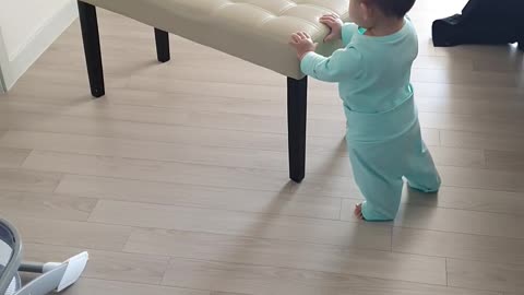 1-year baby is adorbly pulling the chair