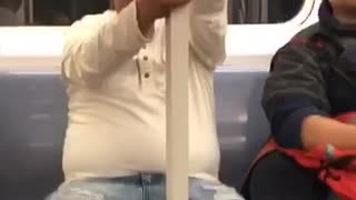 Man on subway with stick pole full of cotton candy