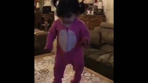 Egyptian baby girl dancing with the cat in a way