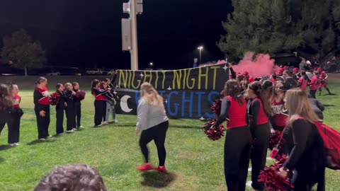 Cheer Coach Gets Knocked Over by Football Team's Playoff Entrance