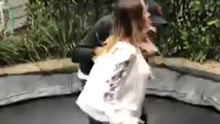 Girl guy back flip trampoline fail