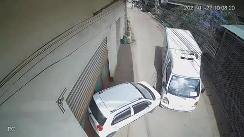 Runaway Truck Pushes Parked Car Into Building