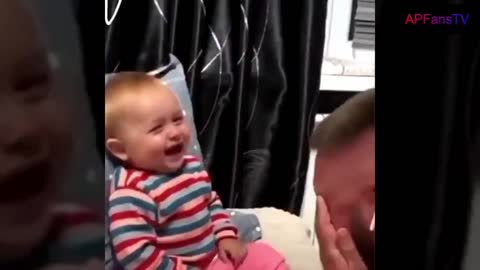 Toddler giggling as father attempted to feed him