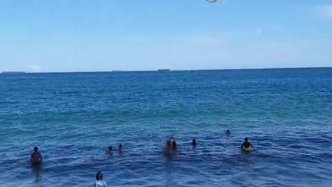 Helicopter boarding over the beach