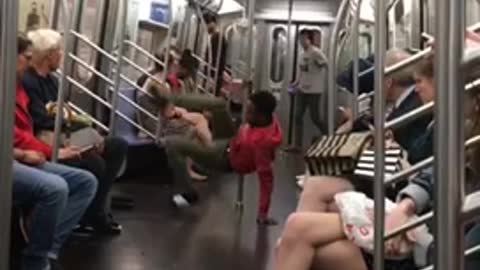 Guy red sweater dancing pole subway needs practice