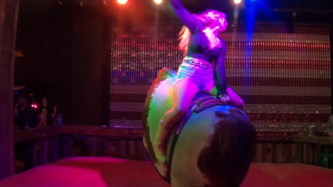 Mechanical bull riding in Las Vegas: A blond cowpoke's first ride of the night ends suddenly