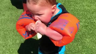 Baby Makes Hilarious Attempts To Eat A Banana While Wearing Floaties