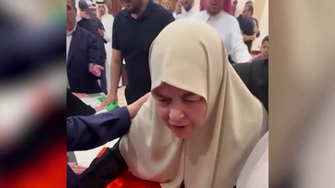 Wife of Hamas chief Ismail Haniyeh mourns next to his coffin