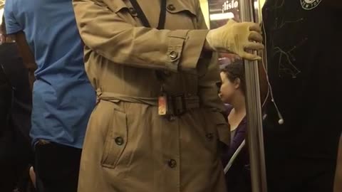 Old man in glasses and trench coat on train