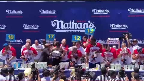 Joey Chestnut CHOKES OUT Leftist Protestor During Nathan's Hot Dog Eating Competition