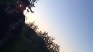 Guy blows fire and lights face on fire in backyard