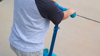 Grandson riding the scooter