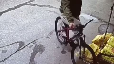Security camera clip of guy riding bike, falling