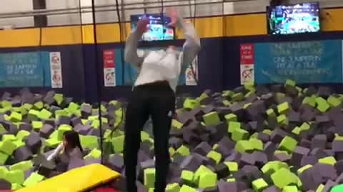 Guy does backflip off off trampoline and lands in foam pit