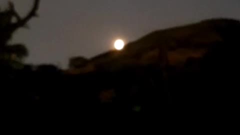 Moon rising behind the mountain.