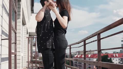 Couple Dancing and Kissing at Balcony