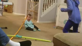 Big sister makes baby laugh with crazy toy.