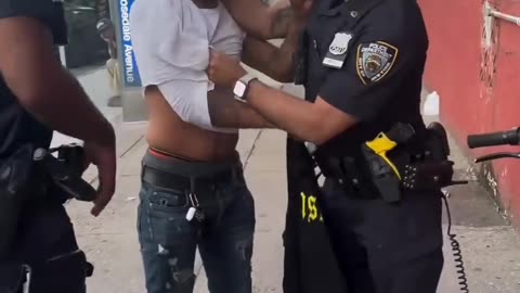 Cop watches as man fights his partner