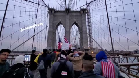 Protesters against mandates cross over the Brooklyn Bridge