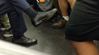 Woman on phone eating cheetos with white gloves subway