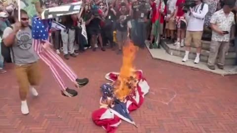 Antifa burn the U.S. flag outside the Capitol.