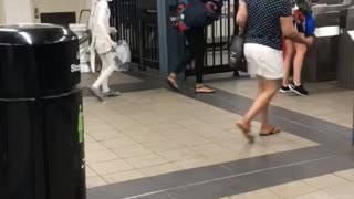 Small person kid dressed in all white subway station