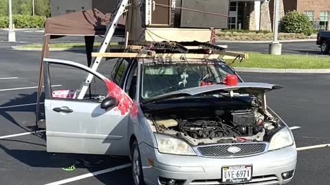 Parking Lot Musician Performs on Top of Car