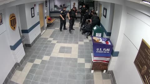 Moment former state worker fires gunshots in police station lobby.
