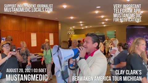Vaccine Police makes an announcement at Clay Clark's Reawaken America Tour