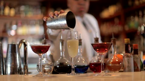 Barmaid preparing a cocktail in the bar