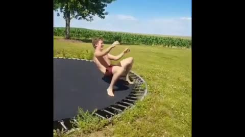 Guy in red shorts fails at trampoline flip